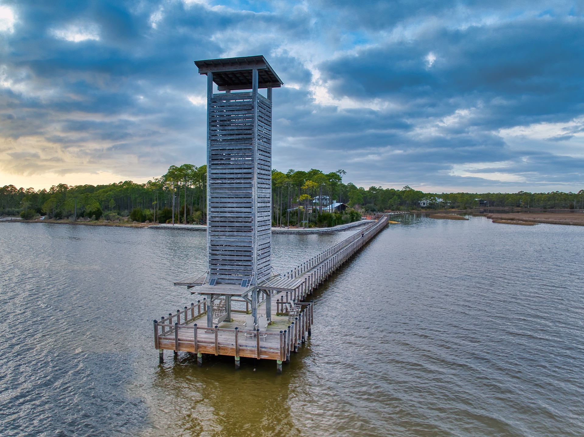 NearDrone operator flying drone at sunset on Gulf Coast beach
