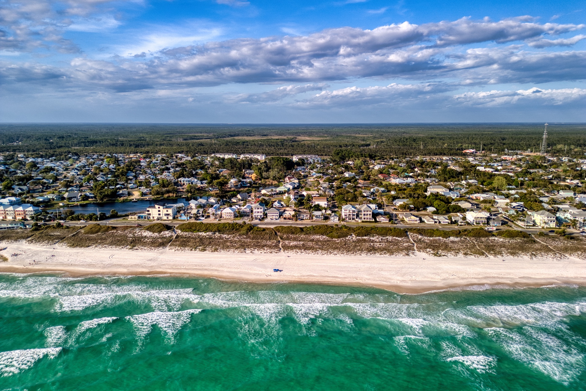 Aerial view of outdoor beachside festival at sunset